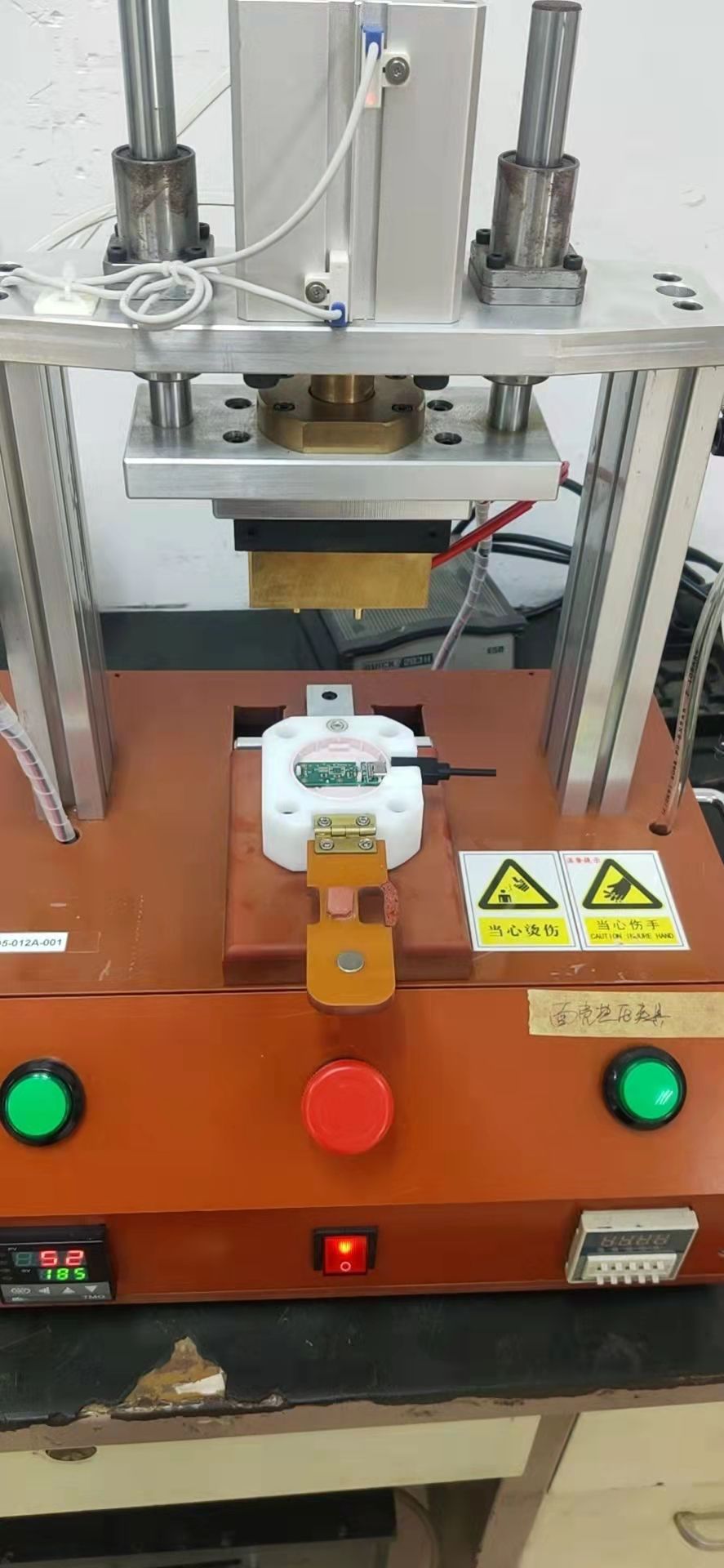 Heat staking fixture for charger assembly